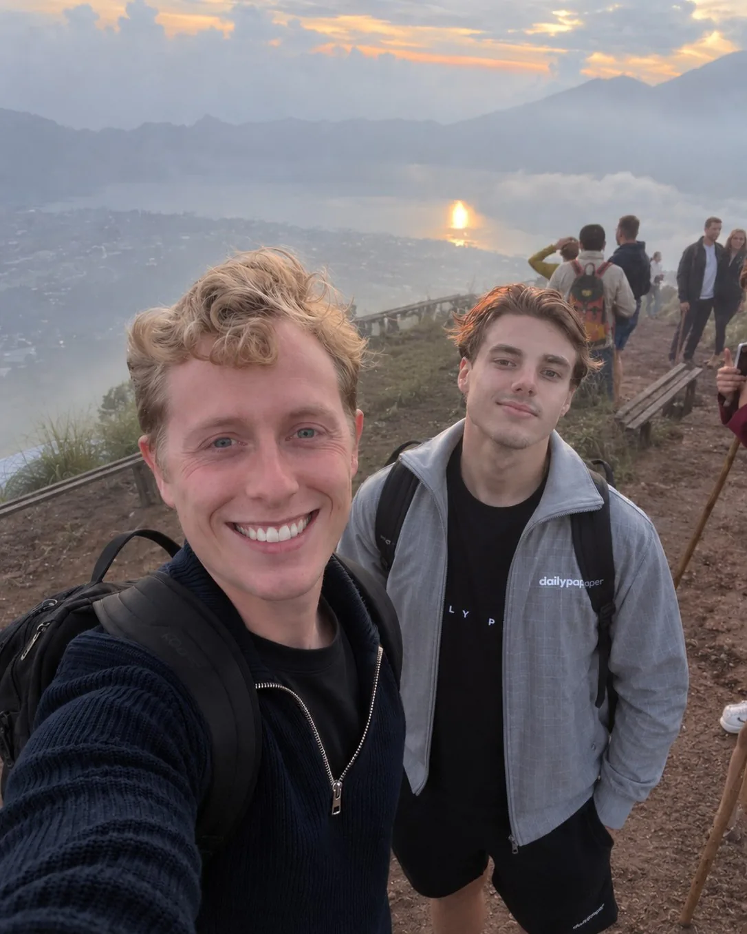 Simon and Tristan at sunrise on a mountain ridge