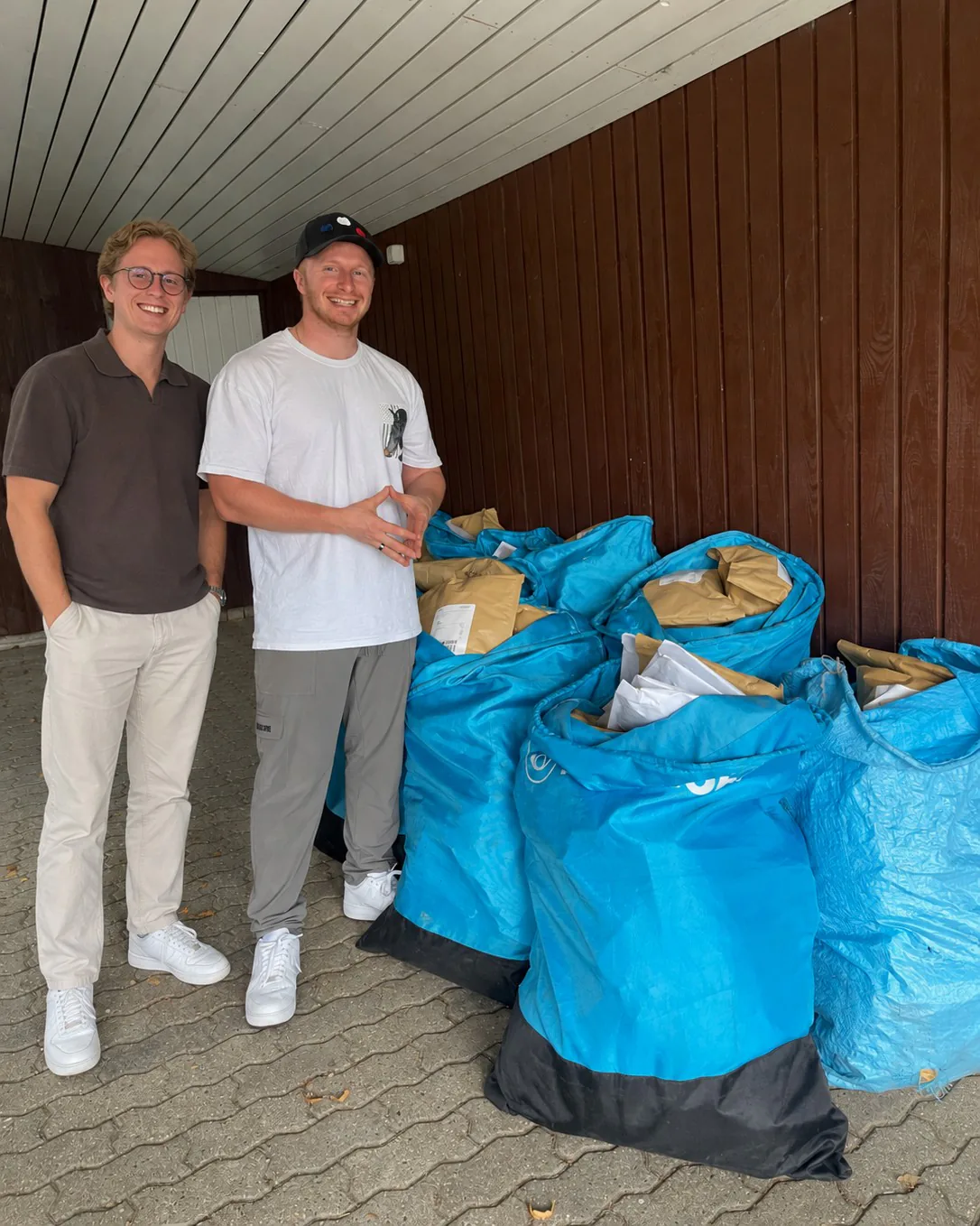 Simon with the SafeCarry team beside bags of packed orders